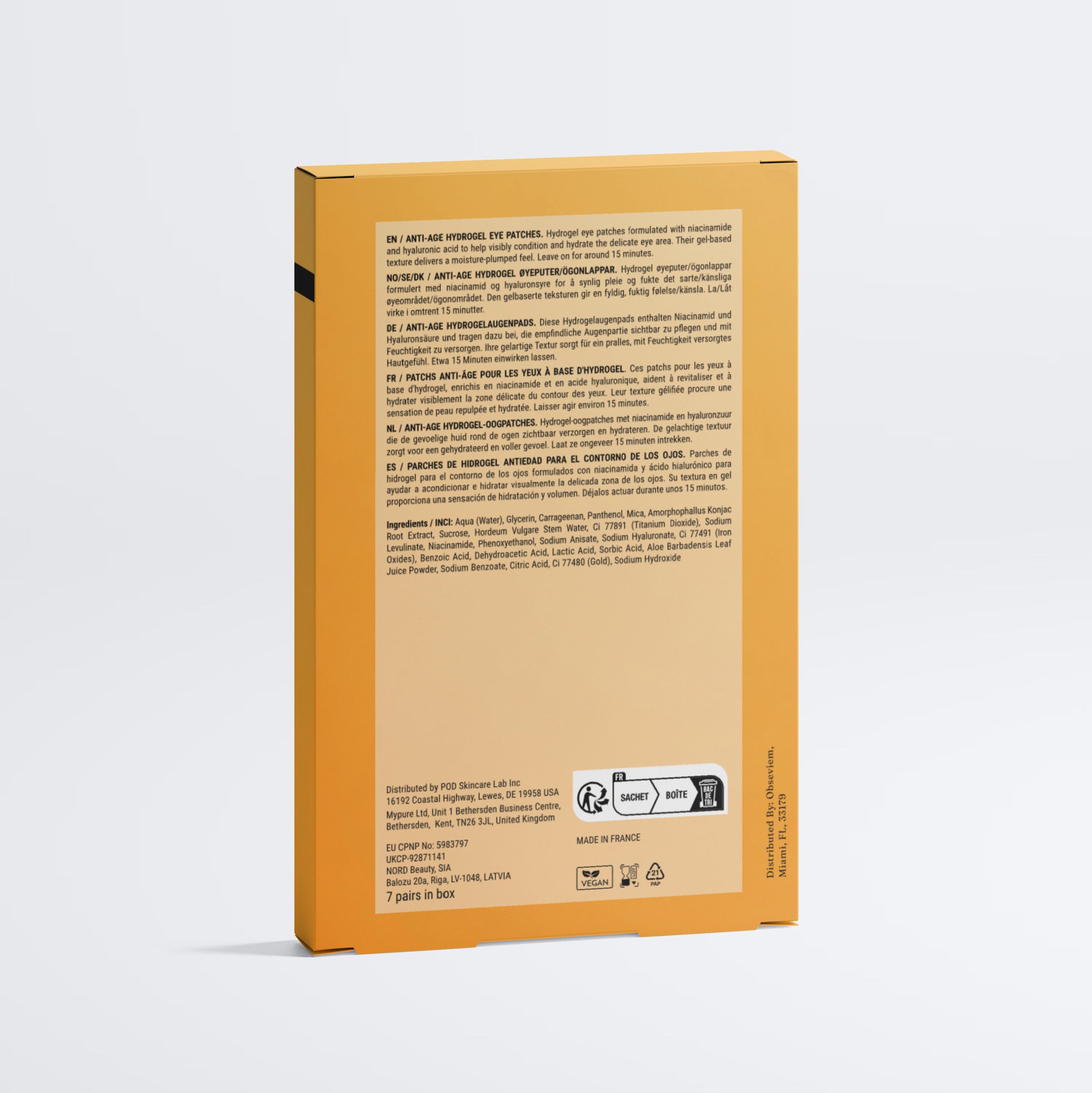 The back of a tall, rectangular yellow cardboard box with dense black text, photographed on a clean light gray studio background.