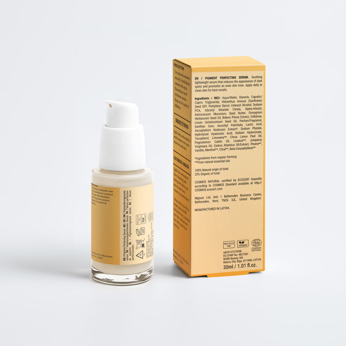 A bottle of liquid foundation with a white pump and a beige label next to its matching beige product box, photographed on a clean light gray studio background.