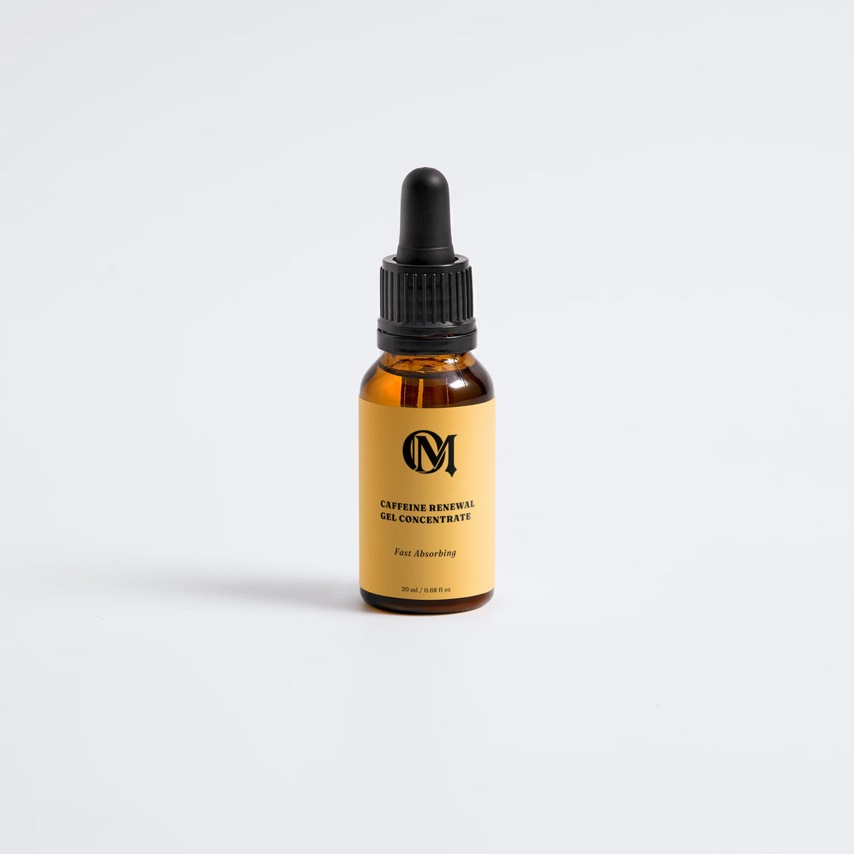 An amber glass dropper bottle of OM Caffeine Eye Serum with a black dropper cap and a tan label, centered on a light gray background.